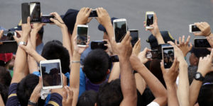 In this Friday, Jan. 16, 2015, photo, Filipino Catholics prepare to take photos, using their mobile phones and tablets, of Pope Francis aboard his Popemobile in Manila, Philippines. Pope Francis is here on a five-day apostolic visit in this predominantly Catholic nation in Asia. (AP Photo/Bullit Marquez)